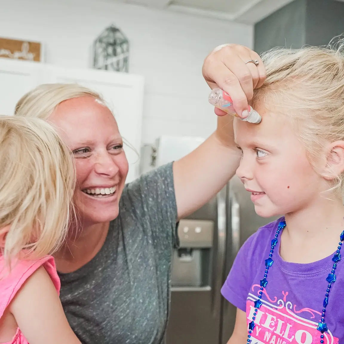 Homeschool mom and her kids making a Recipe Box project at the kitchen table