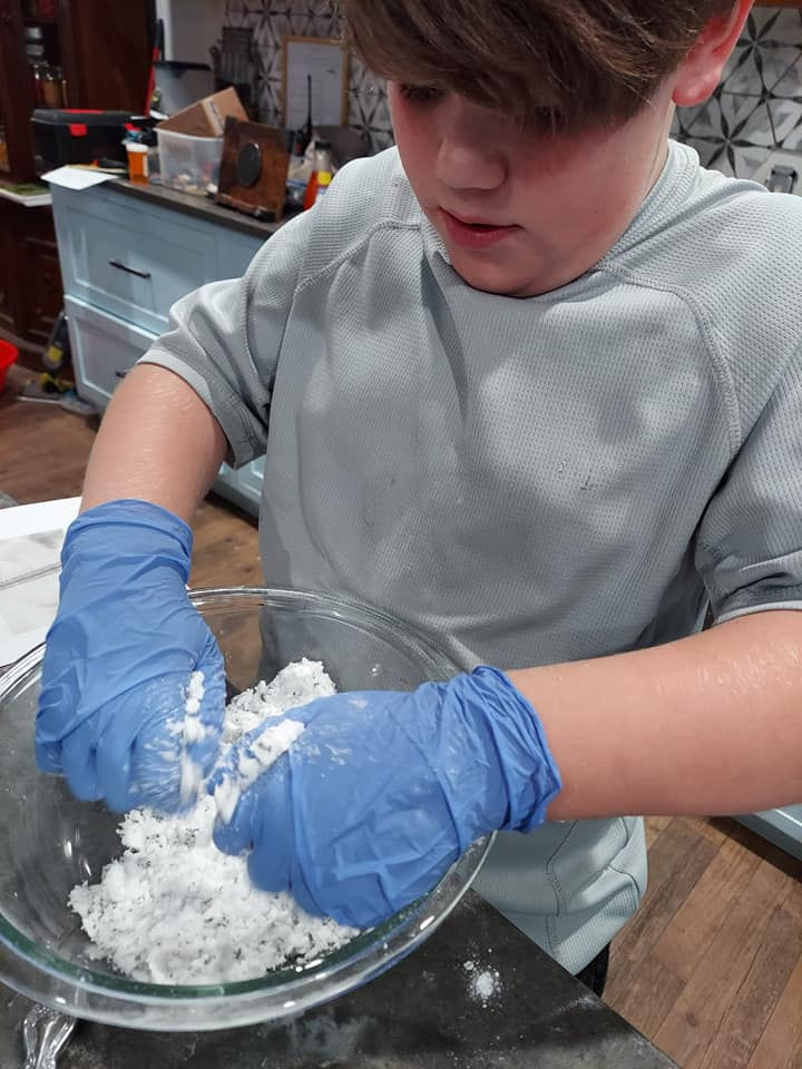 Family running the Hand Soap Maker Kit at the kitchen table