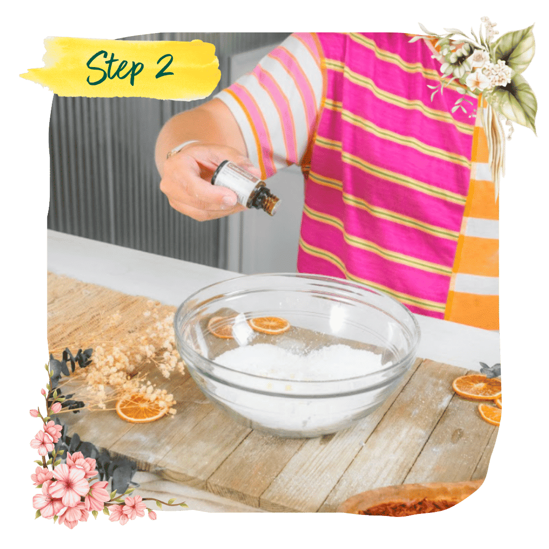Step 2 &mdash; a maker at her kitchen counter dripping essential oil into a glass beaker of cream
