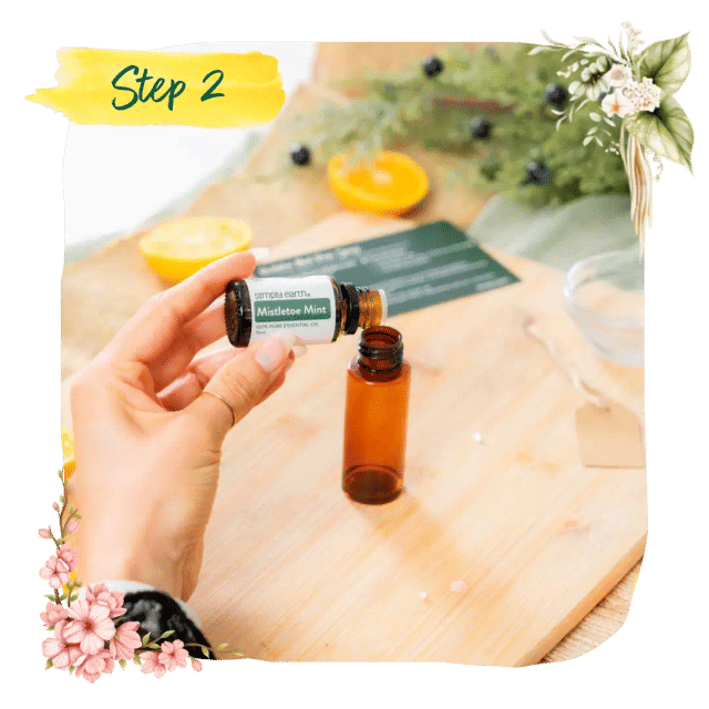 Step 2 &mdash; dripping Mistletoe Mint essential oil from its bottle into an amber bottle