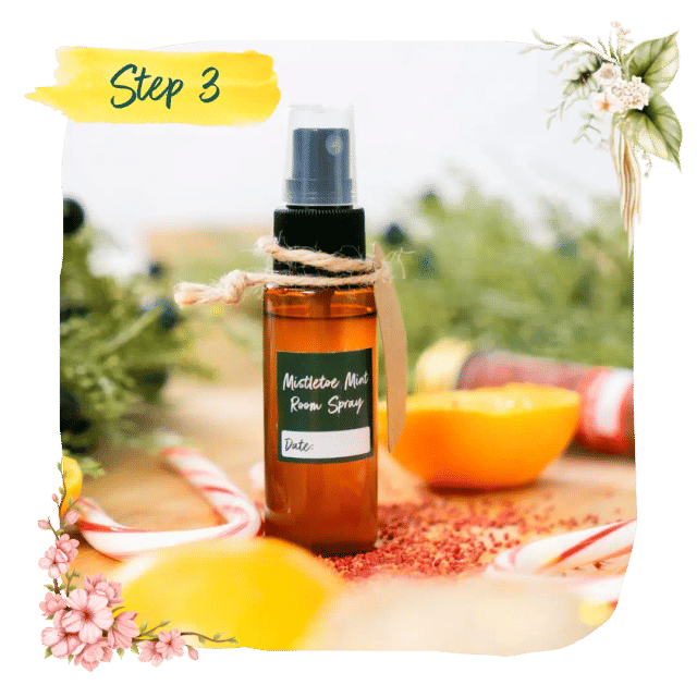 Step 3 &mdash; a finished bottle of homemade Mistletoe Mint room spray among oranges and candy canes